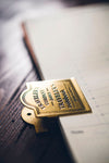 TRAVELER'S Notebook Brass Clip - Logo